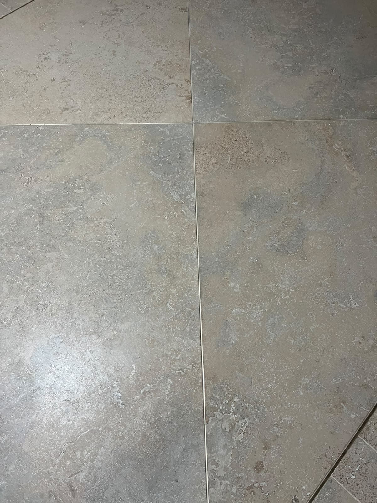 Top-down view of four-way floor tile intersection demonstrating flush zero-lippage joint alignment in Askari 10, Islamabad