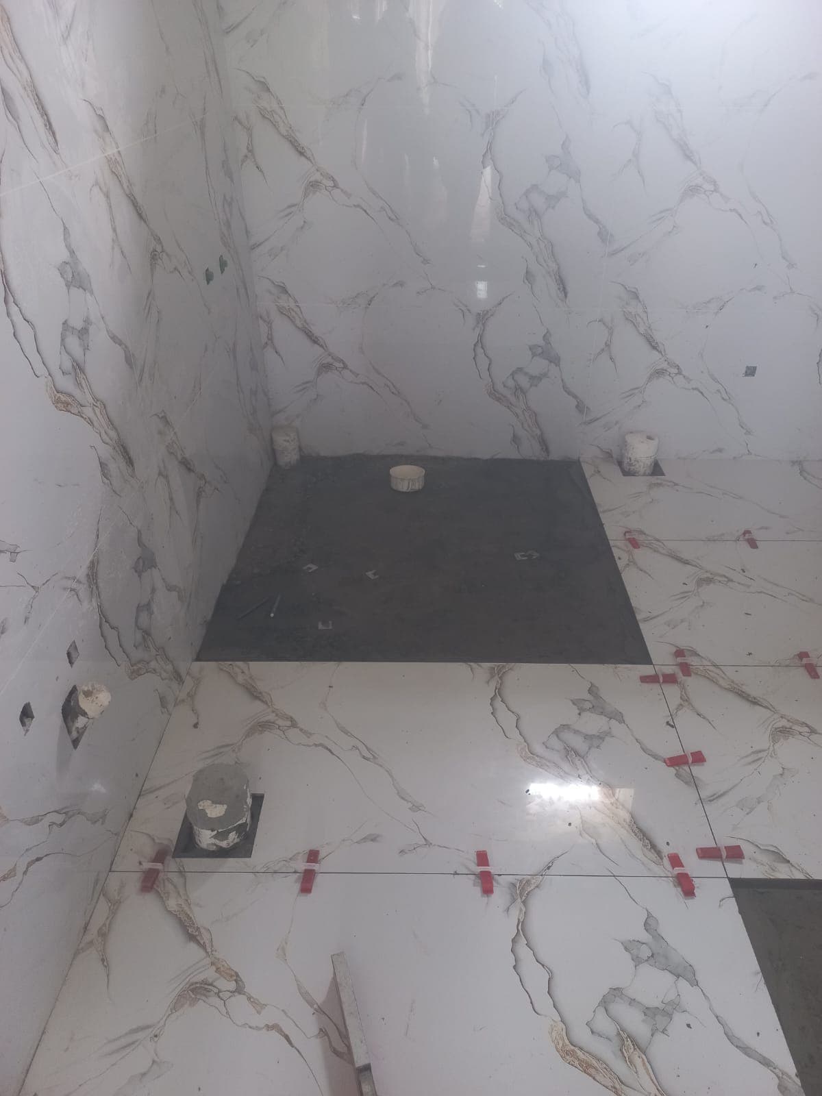 Calacatta marble-look porcelain bathroom wall and floor tiling with levelling clips and sunken shower preparation in F-6 / F-7 Islamabad