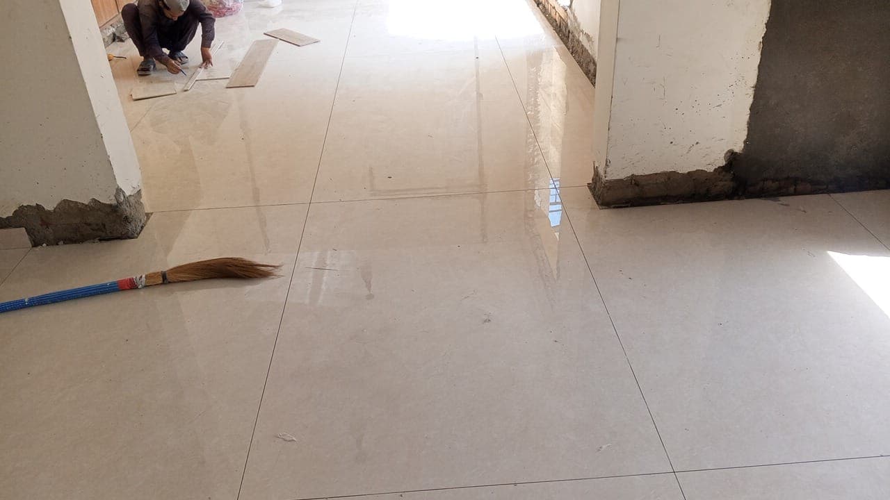 ArcheTiles technician precision cutting and fitting large-format floor tiles on site in F-6 / F-7 Islamabad