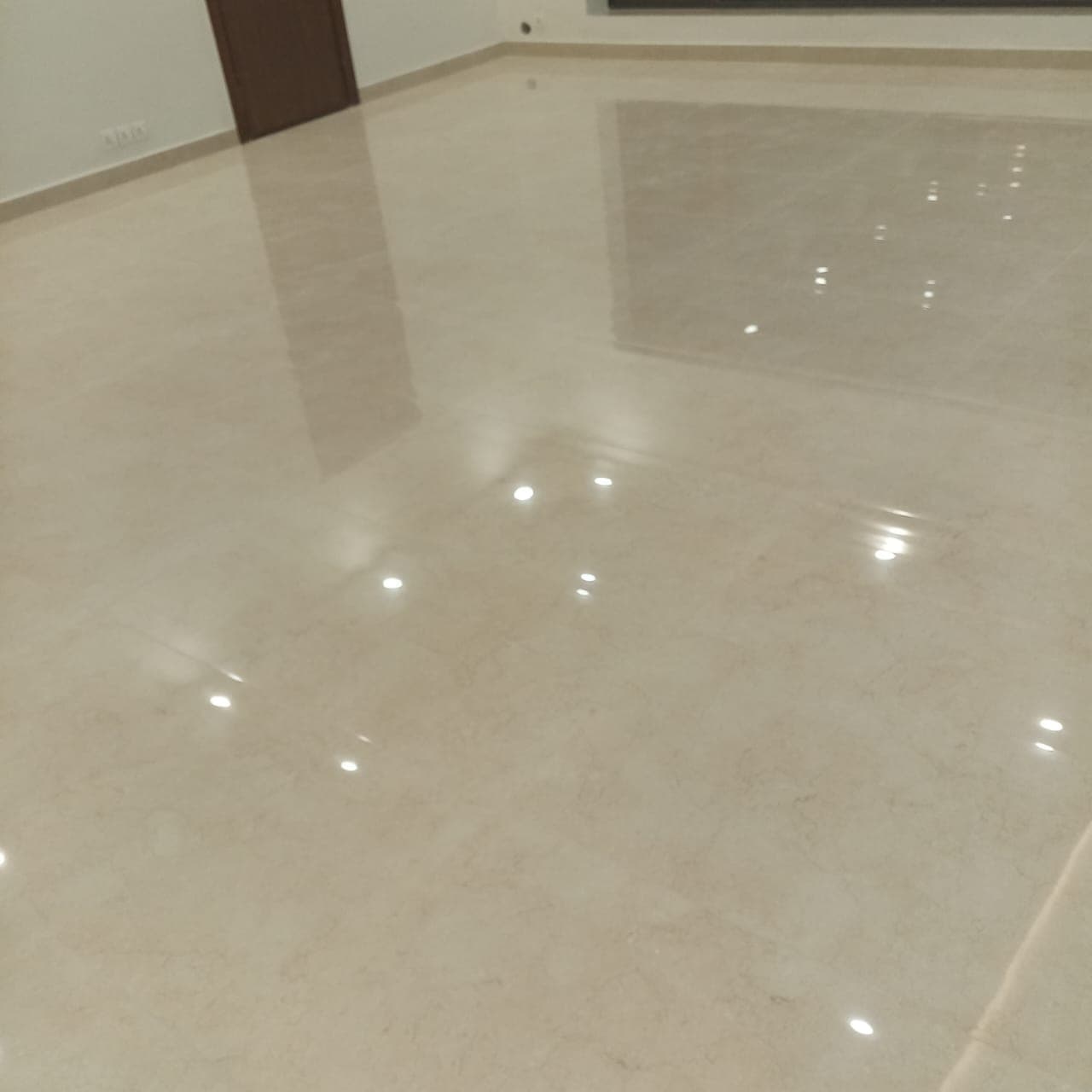 High-gloss polished porcelain floor tiling with zero lippage across a spacious residential hall in F-6 / F-7 Islamabad